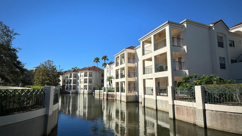 a white building next to a body of water