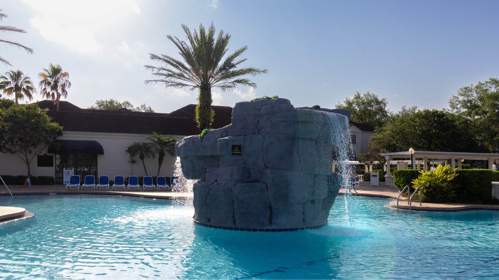 a large rock fountain in a pool