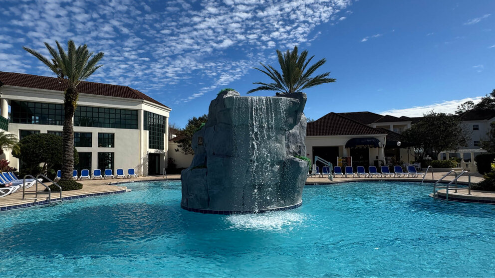 a large rock fountain in a pool