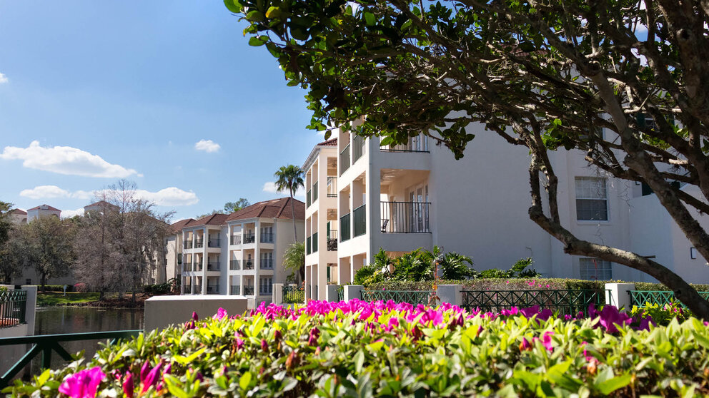 a group of buildings with trees and flowers