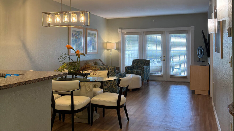 a living room with a table and chairs