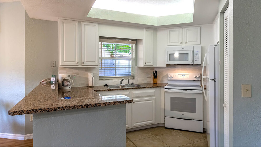 a kitchen with a granite counter top and a microwave