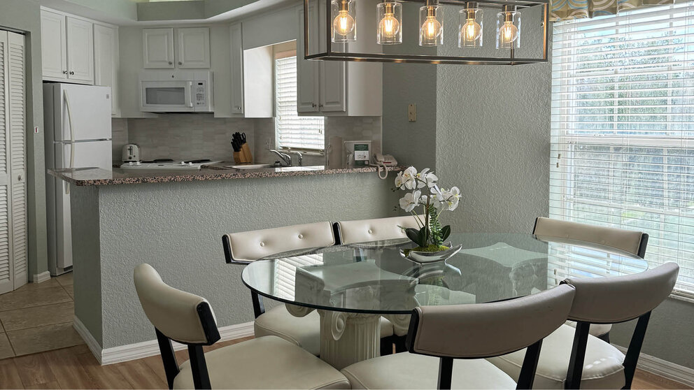 a dining table with chairs in a kitchen