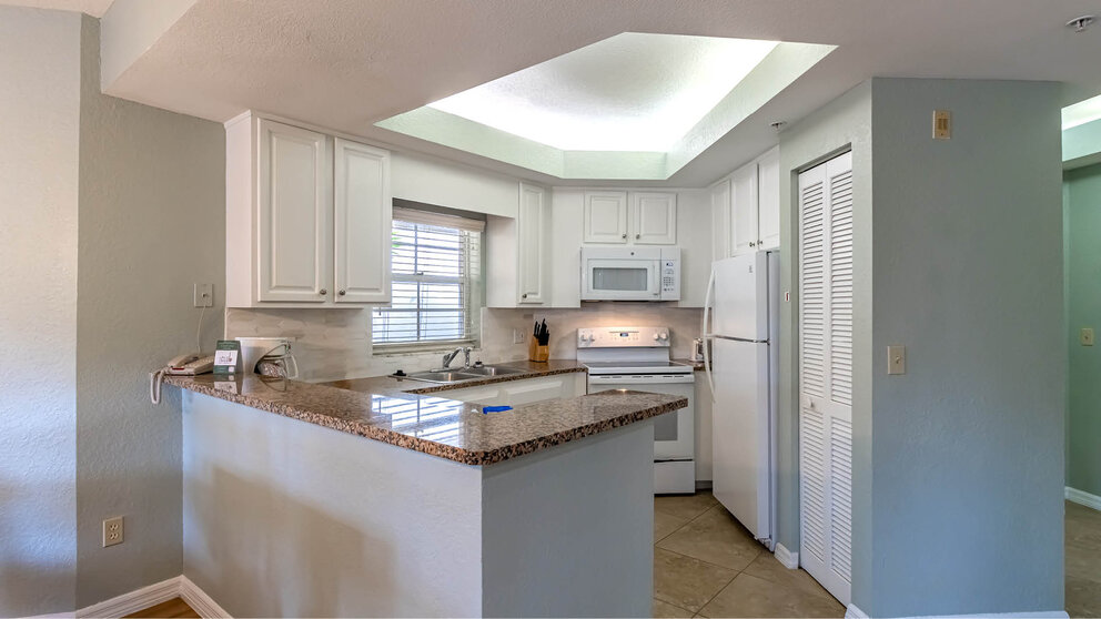 a kitchen with a marble counter top