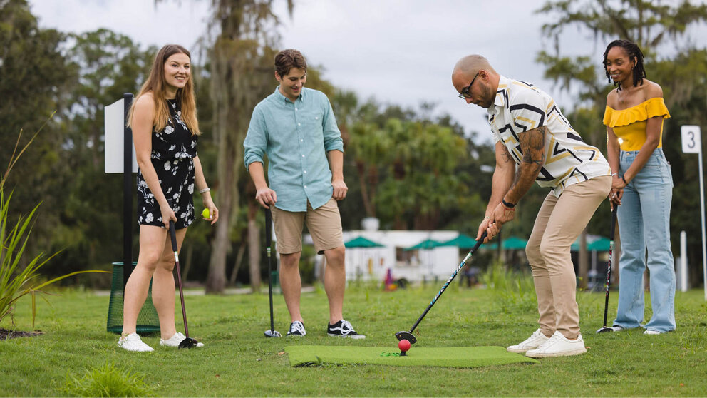 a group of people playing mini golf