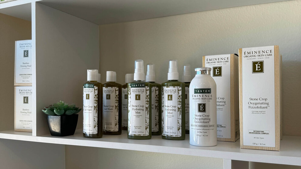a shelf with bottles of shampoo and a book