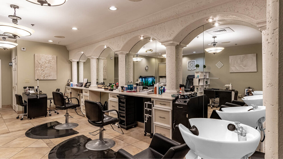 a room with a mirror and chairs