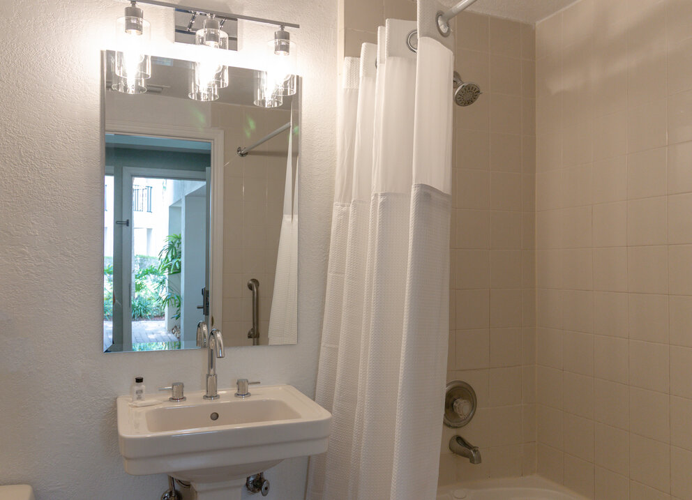 a bathroom with a shower curtain and a bathtub