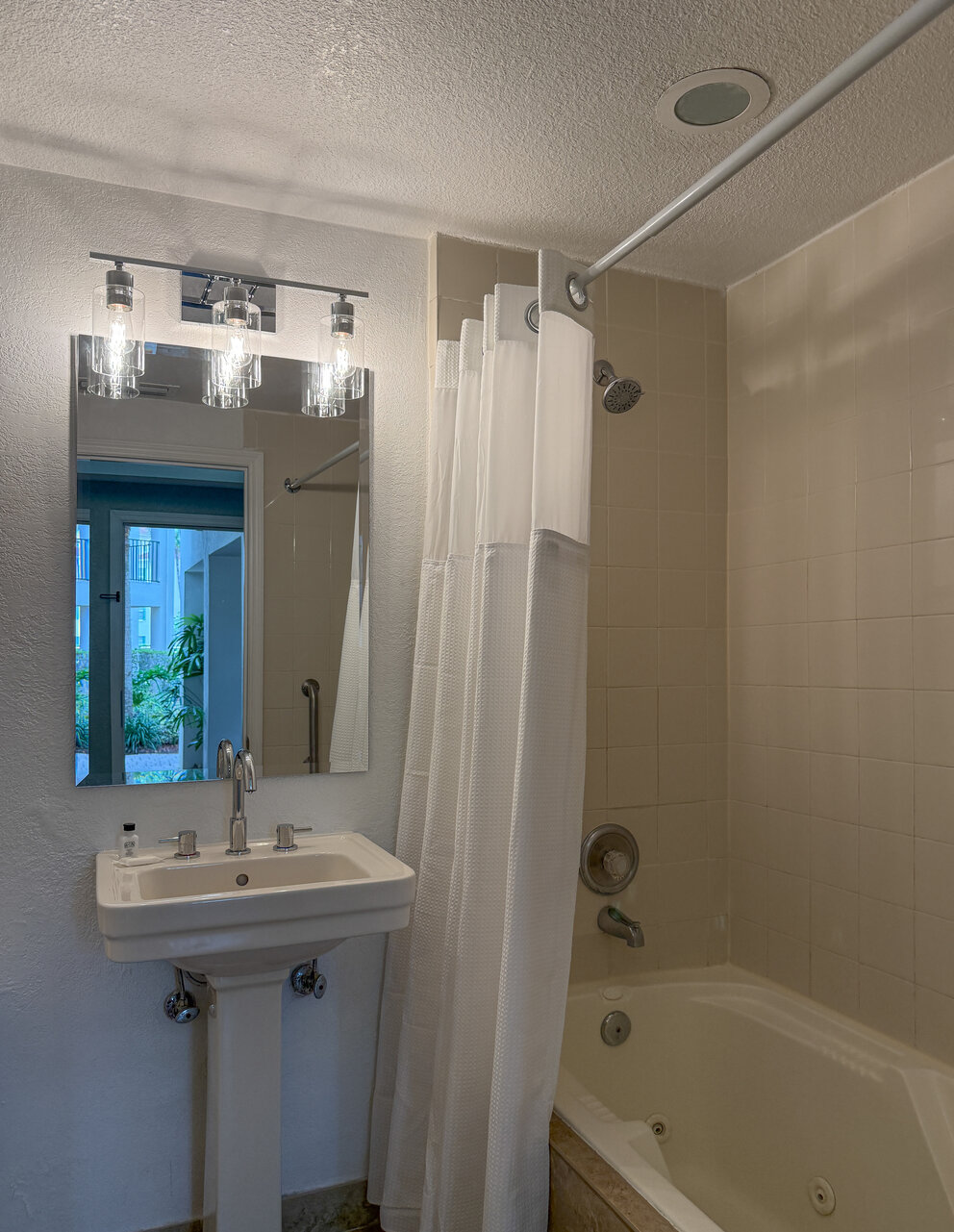 a bathroom with a shower curtain and sink